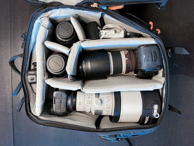 Mark Dunsmuir's bag opened from above: camera bodies with telephoto lenses and lens caps in the padded dividers
