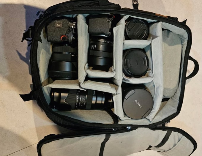 Paul Goh's bag opened from above: two camera bodies with lenses and lens caps in the padded dividers